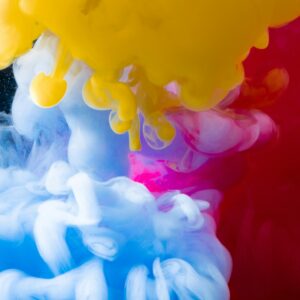 Dynamic underwater ink explosion with vibrant colors creating a mesmerizing abstract art piece.