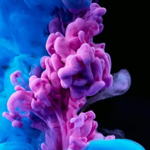 Stunning capture of colorful ink diffusing in water, showcasing vibrant blues and purples.